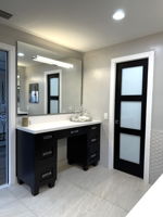 Make up vanity and opaque glass door leading to the private toilet