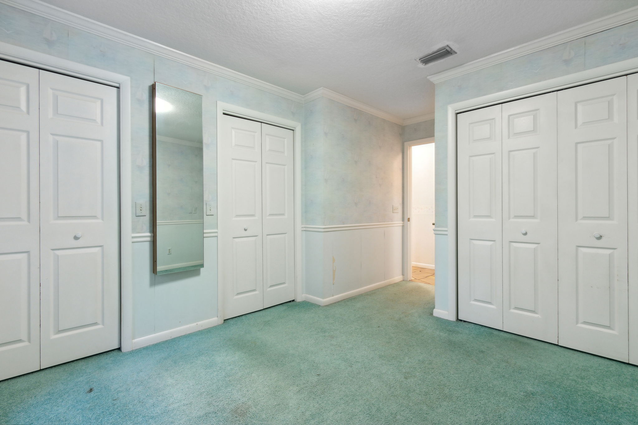 Bedroom 3 with plentiful closet space and a surprise behind the mirror