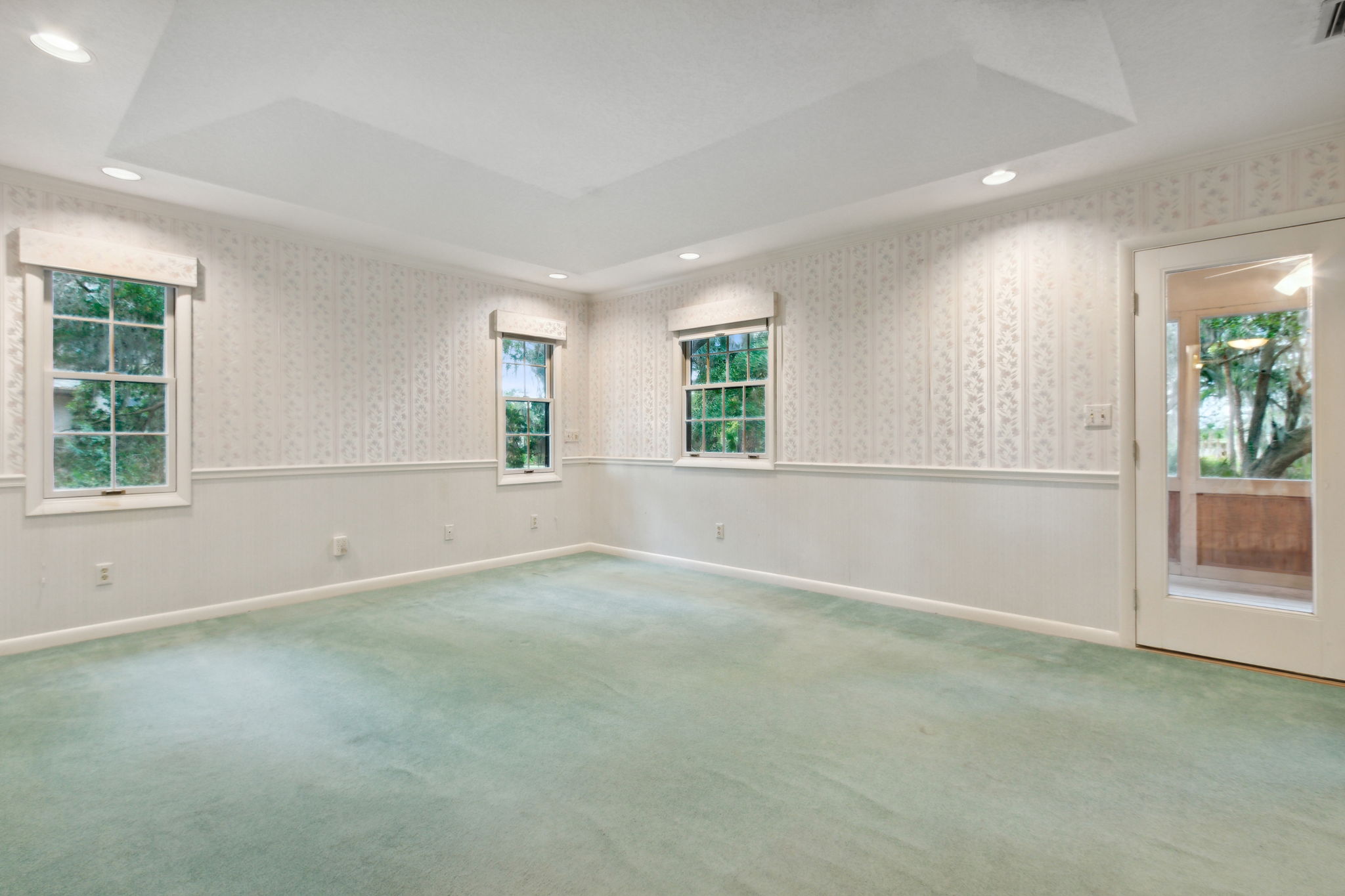 Primary Bedroom with tray ceiling and private screened porch