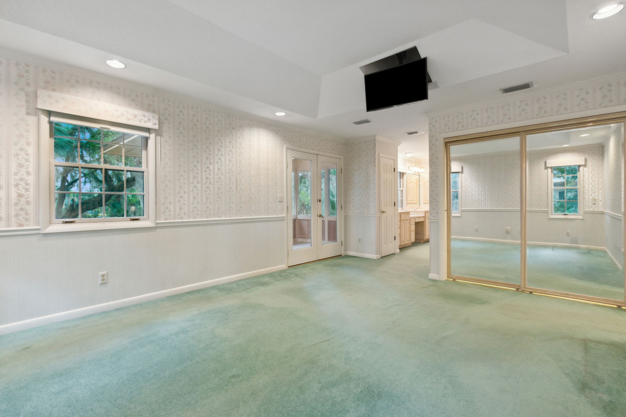 Primary Bedroom with crown and chair rail molding