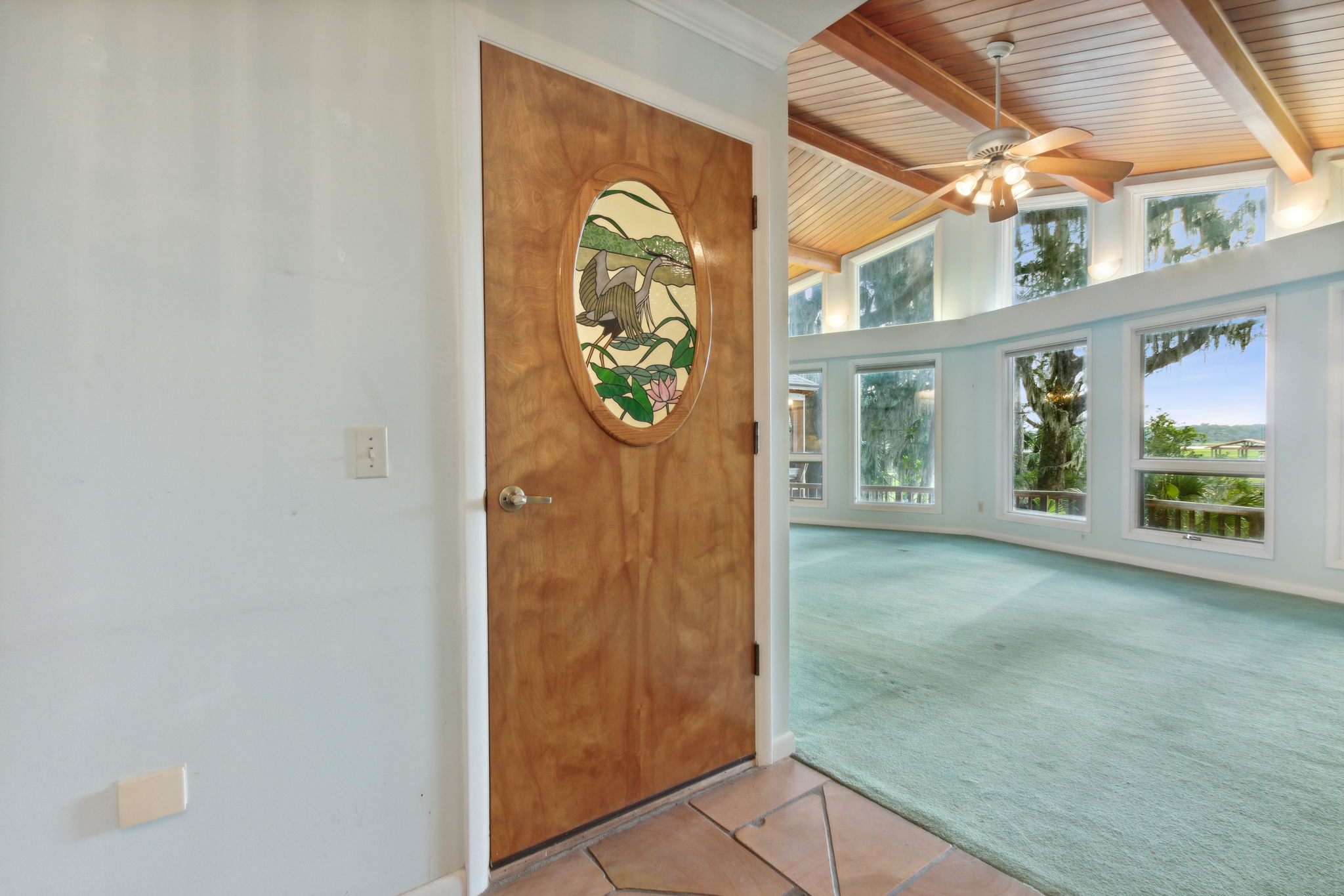 Stained glass door signals the entrance to the downstairs if you can stop looking at the view