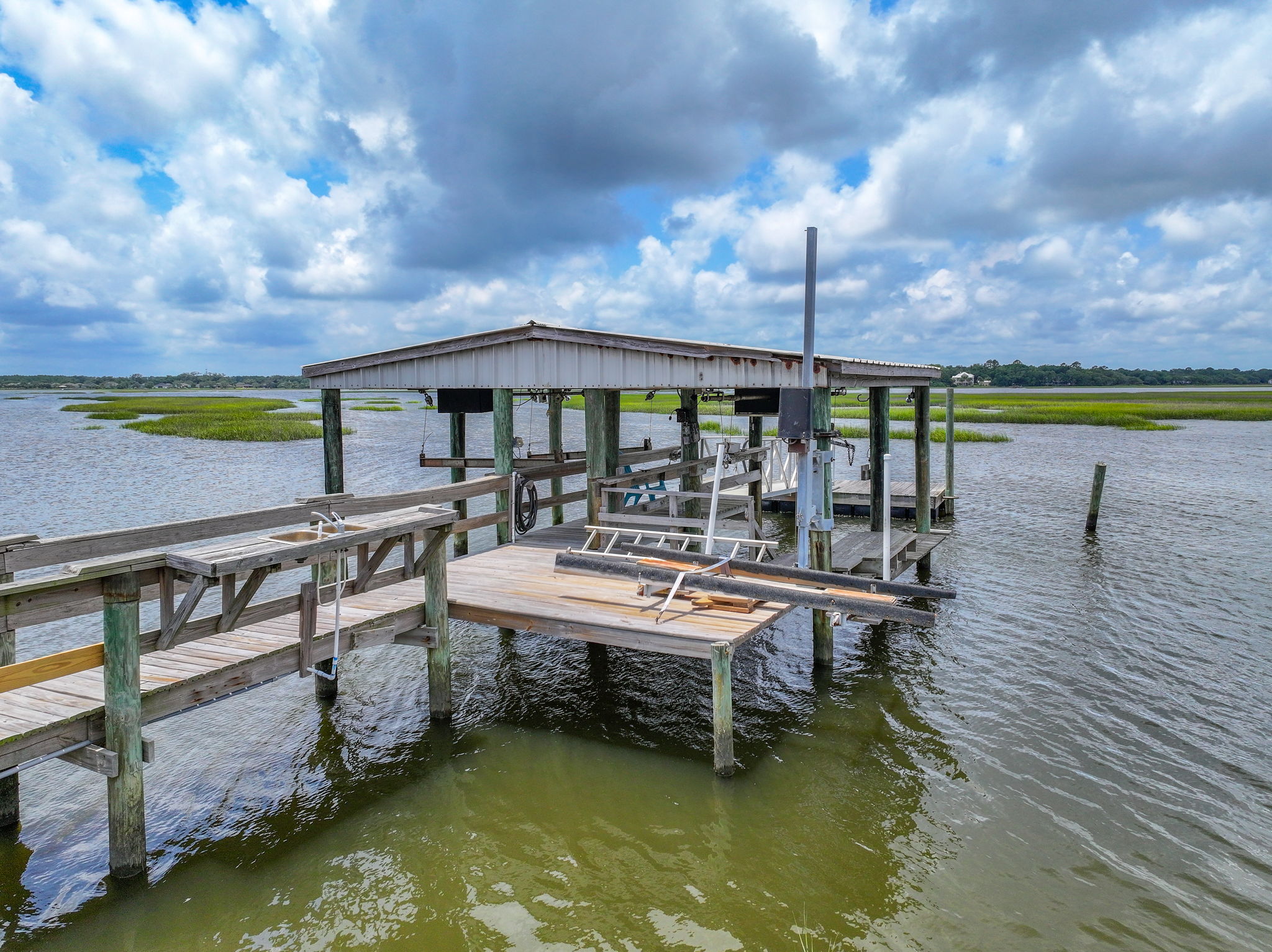 Dock with 2 boat lifts, new floating dock, fish cleaning station with sink