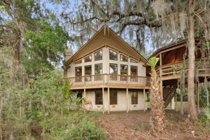 Designed like a ship's prow as the home overlooks the marsh and water.  Crowned with select Cypress, the back of the home makes a statement!