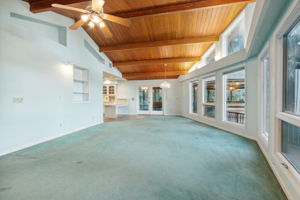 Great Room with Select Cypress beams and tongue and groove ceiling.  Notice the lighting over the windows