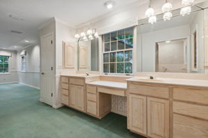 Primary Bathroom with dual sinks, great countertop and storage space