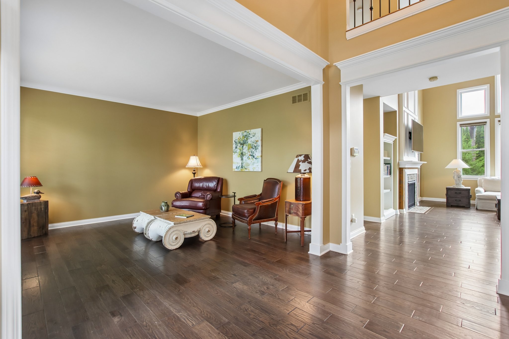 Soaring 2 story foyer opens to Great room with 2-story windows with feature fireplace