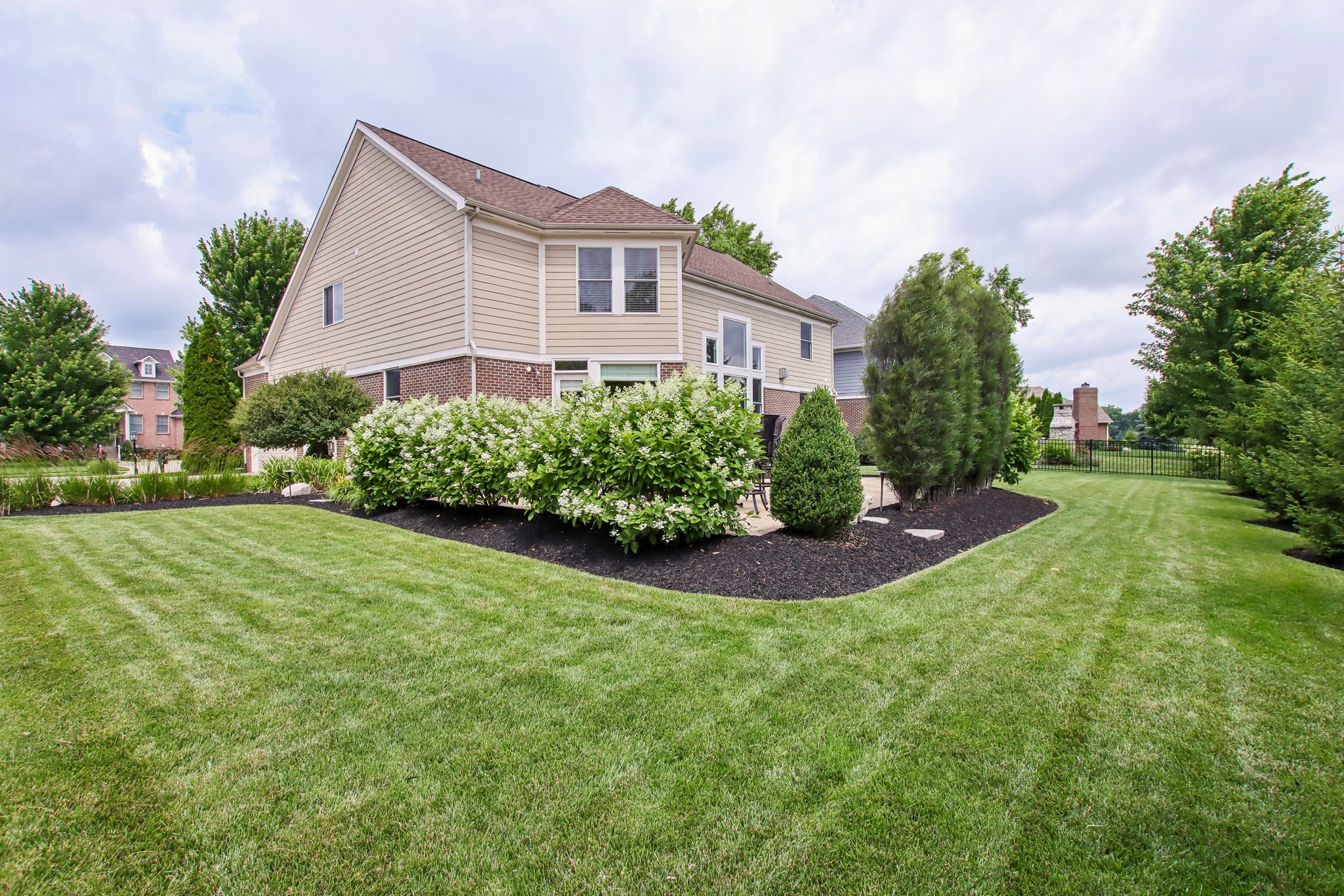 Enjoy your private outdoor oasis with the mature plantings, and walk paths to the lush lawn