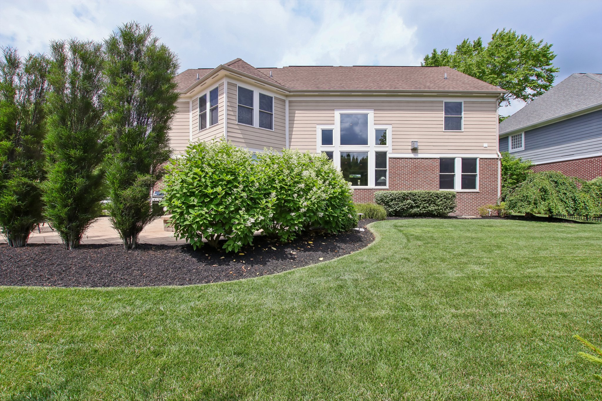 Enjoy your private outdoor oasis with the mature plantings, and walk paths to the lush lawn
