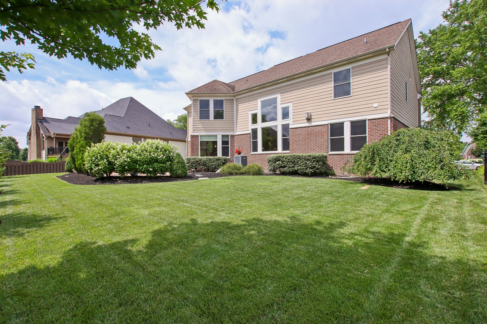 Enjoy your private outdoor oasis with the mature plantings, and walk paths to the lush lawn