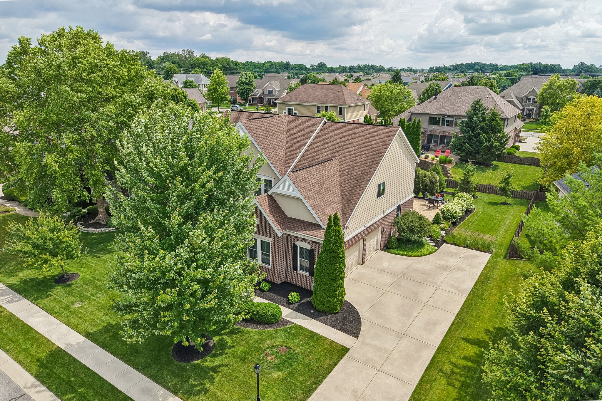 Aerial view from the front of the home showcasing the extended driveway and side yard