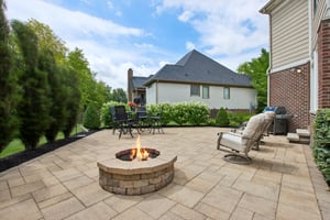 Oversized custom paver patio offers firepit and tons of privacy with mature plantings