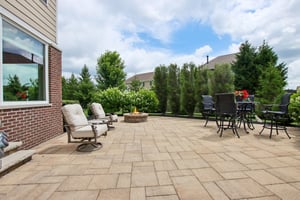 Oversized custom paver patio offers firepit and tons of privacy with mature plantings