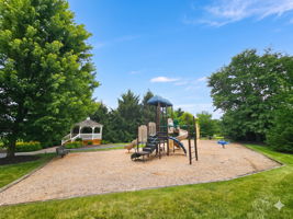 Community play area with climbing structure, seesaw, with swings, picnic table, gazebo