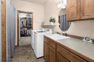 Laundry Room Features Utility Sink, Large Counter, Cabinets & 2 Storage Closets