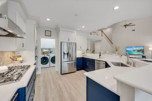 Beautifully updated kitchen with quartz countertops, gas stove, and stainless steel appliances