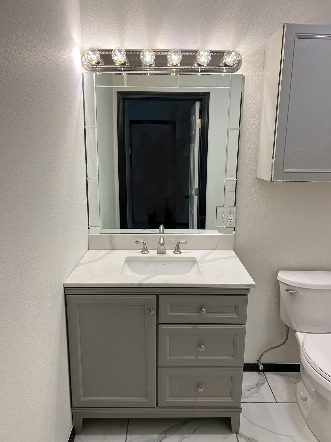 Custom lighting and mirror in guest bath