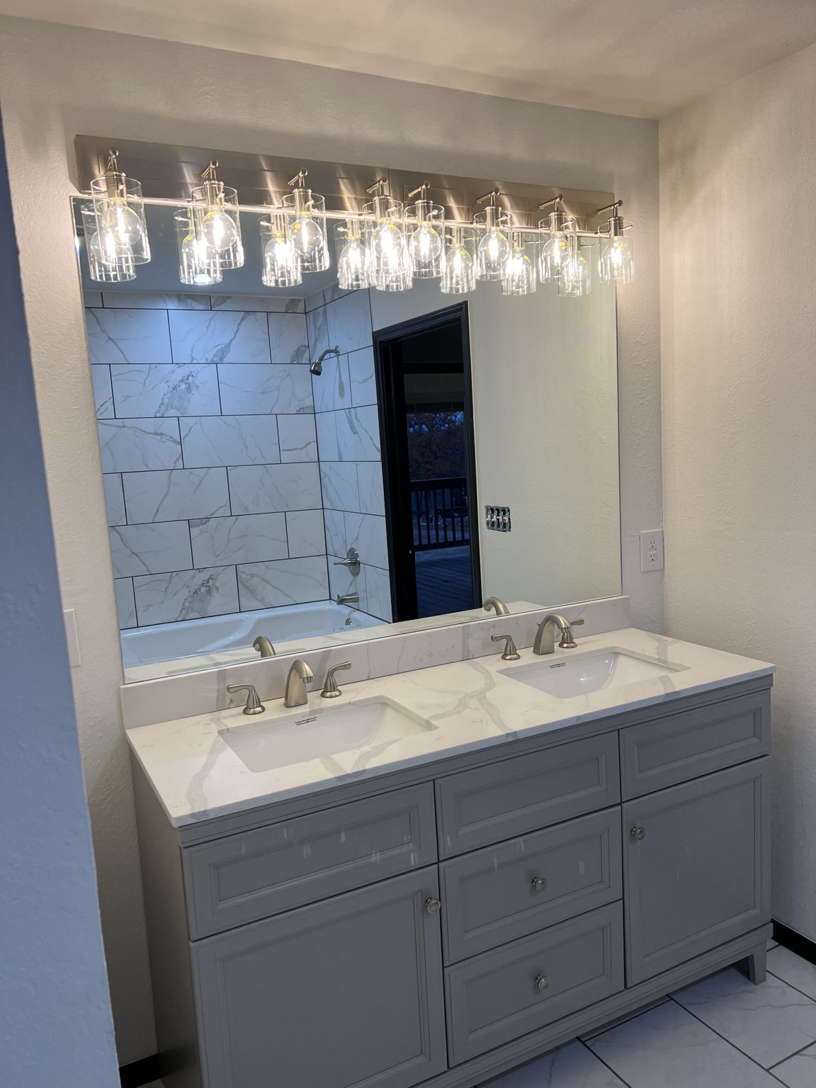 Elegant lighting and double sinks in master bath