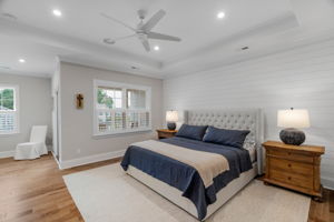 Primary Bedroom with tray ceiling, accent wall, sitting room and private balcony