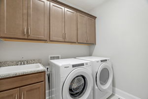 Laundry room with custom cabinets and sink