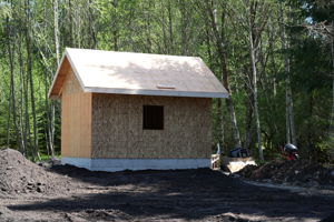 Riverside community well house